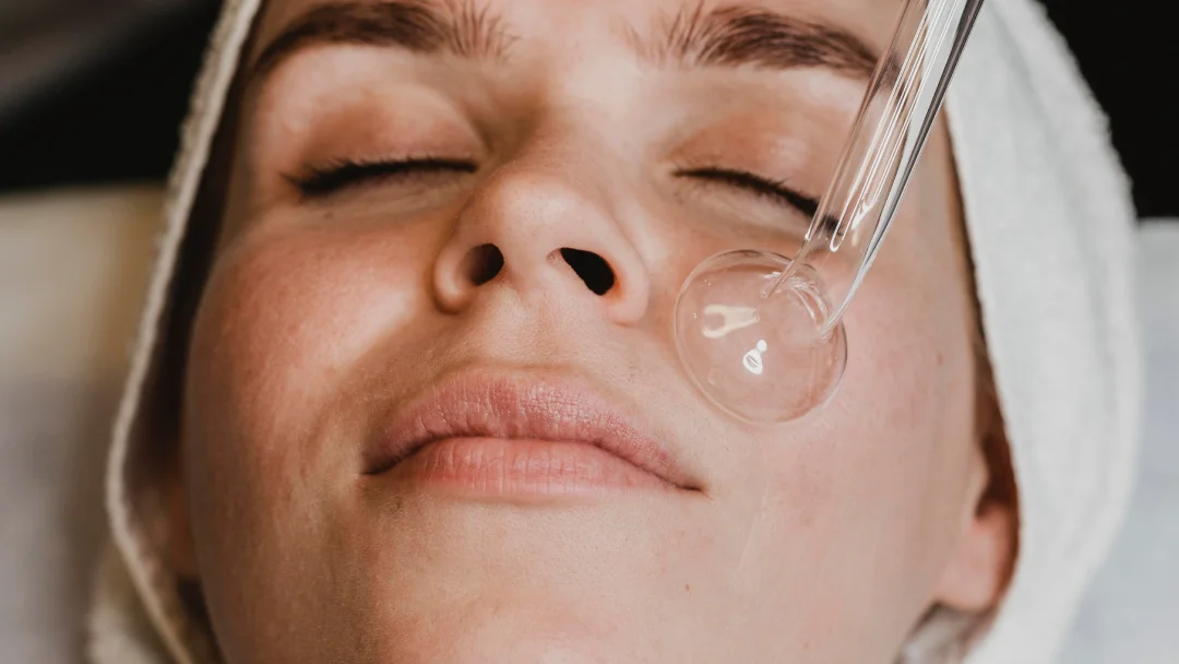 Une femme reçoit un soin du visage avec un masque lors d'un Hydrafacial à Montréal.